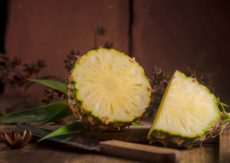 Sliced pineapple on wooden table.の写真素材