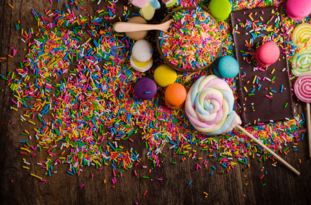 Colorful candy and Chocolet, Macaron on wooden table.
