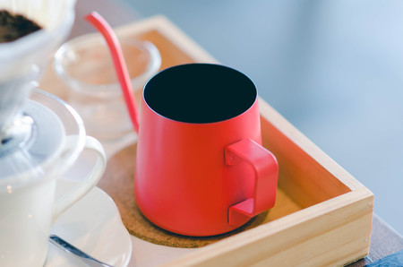 Close up red kettle with coffee dripping. Still life photography, Kit for making drip coffee.の写真素材