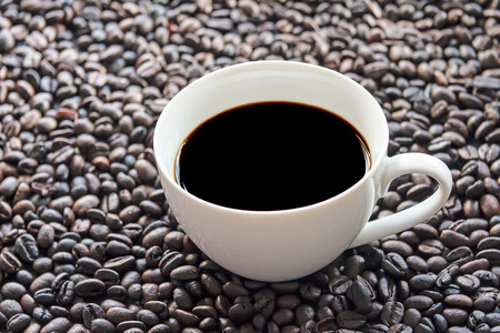 A cup of coffee with beansの写真素材