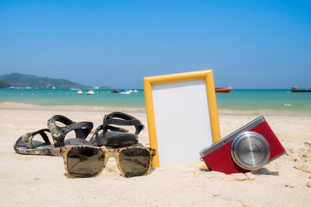 Summer time concept,frame,camera,shoes and glasses on the beachの写真素材