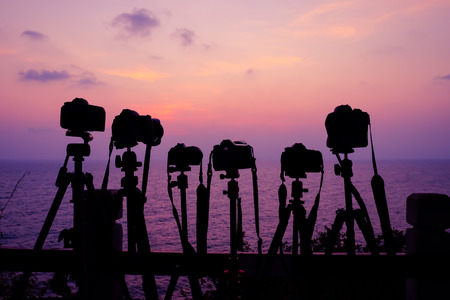 Silouhette 6 cameras on sunset seascape backgroundの写真素材