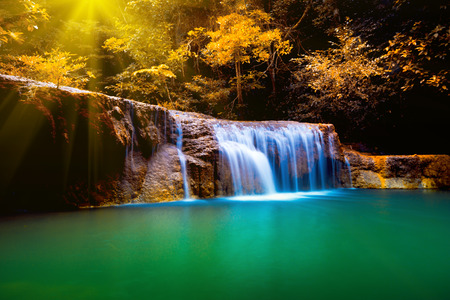 Erawan waterfall in Thailand in deep forest with sunbeam