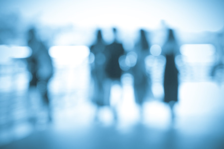 Blurred abstract people background, silhouettes of people walking on a streetの写真素材