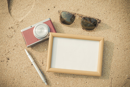 Summer time concept,frame,camera and glasses on the beachの写真素材