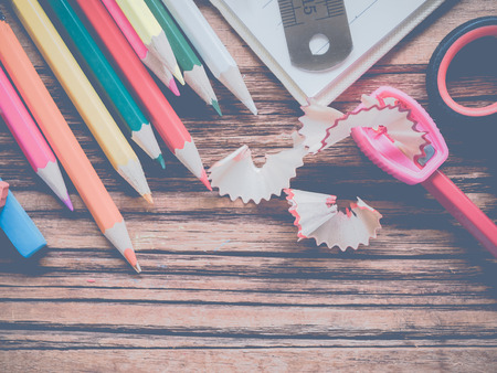 Close up school and office supplies on wood background.