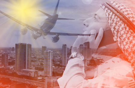 Double exposure Arab Man talking smartphone for business airline ,business conceptの写真素材