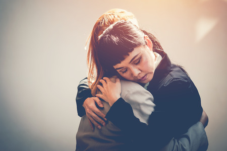 Two women hug to consoleの写真素材