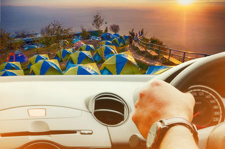 IFront view of car looking out from inside with camp on beautiful and famous travel locationの写真素材