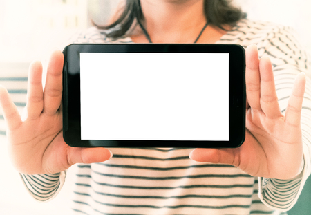 Woman holding blank screen smartphoneの写真素材