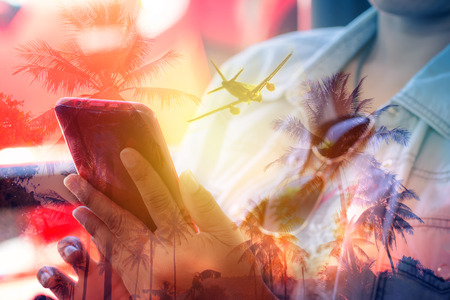 Double Exposure woman using smartphone for booking trip travel islandの写真素材