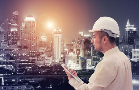 Construction worker with cityscape backgroundの写真素材