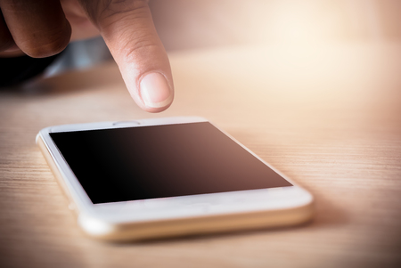 Man pointing to the black screen of a smartphone.の写真素材