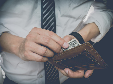 Men carry a purse with a little money.の写真素材