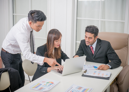 Businesswoman and businessman on meeting in modern bright office interior and working on laptopの写真素材