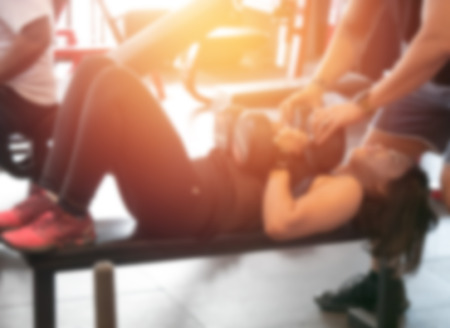 Abstract blurred image fit woman and coach doing exercise. Concept of healthyの写真素材