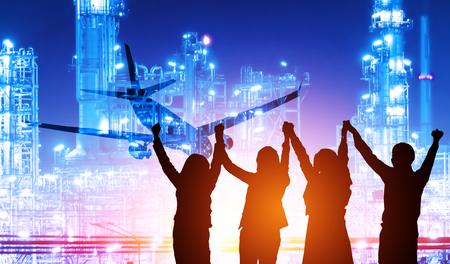 Doble exposure airplane and oil refinery with businesspeople make high hands when business success,power industry conceptの写真素材