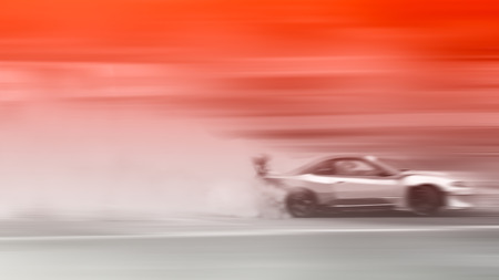 Car drifting, Blurred of image diffusion race drift car with lots of smoke from burning tires on speed trackの写真素材