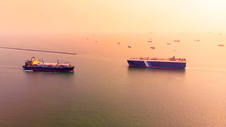 Aerial view of shipping and cargo for export and import of goods in Thailand waters at sunset.Transportation international concept.の写真素材