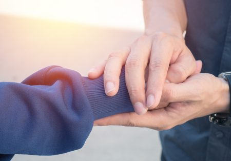 Men holding hands with women with love and caring.