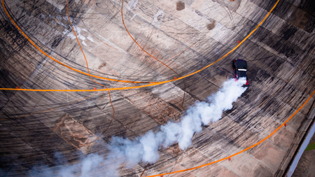 A view from the air racing drift car with a lot of smoke on the blurred speed track. In the trophy.の写真素材