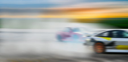 Car drifting battle, Blurred of image diffusion race drift car with lots of smoke from burning tires...