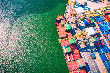 Aerial view of cargo ship loading container and cargo plane. Logistics and transportation of International. Business import export and logistic concept.のeditorial素材
