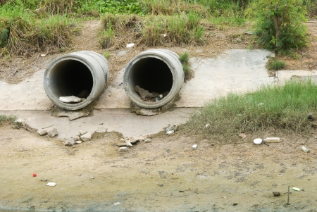 Concrete drain pipe, polluting to riverのeditorial素材