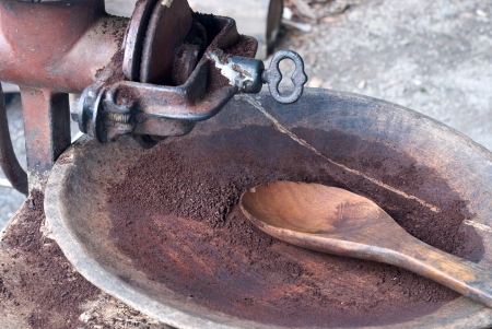 Black Roasted Arabica coffee grinding in old grinder in Mae Klang Luang Village, Thailandの写真素材