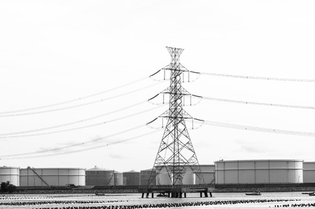 Electricity Pylons over tank farm in  Thailand