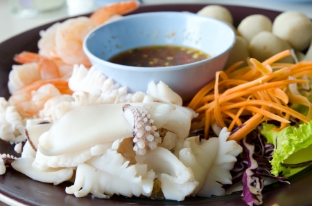 Delicious seafoods ,Steamed squid and shrimp with Thai style hot and spicy dipping sauceの写真素材