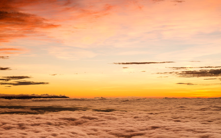 Dramatic sunrise over valley of fog a view from top of mountain, Thailandの写真素材