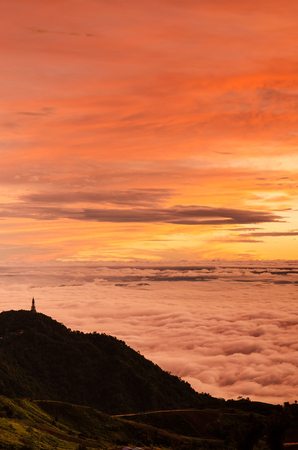 Dramatic sunrise over valley of fog a view from top of mountain, Thailandの写真素材
