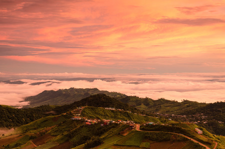 Dramatic sunrise over valley of fog a view from top of mountain, Thailandの写真素材