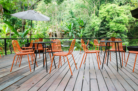 Colorful chair in wooden porch in green forestの写真素材