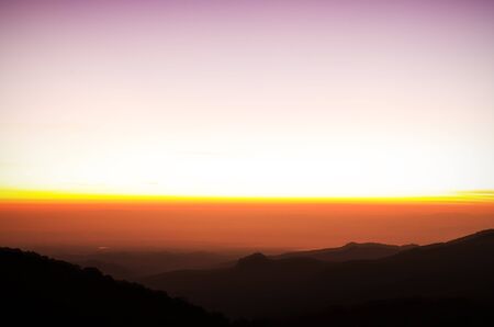 Dramatic sunset over mountain backgroundの写真素材