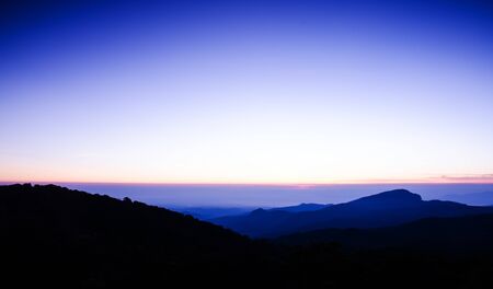 Dramatic sunset over mountain backgroundの写真素材