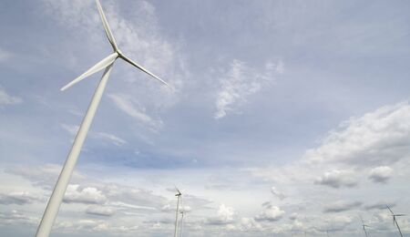 Wind turbine generators over blue skyの写真素材