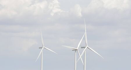 Wind turbine generators over blue sky
の写真素材