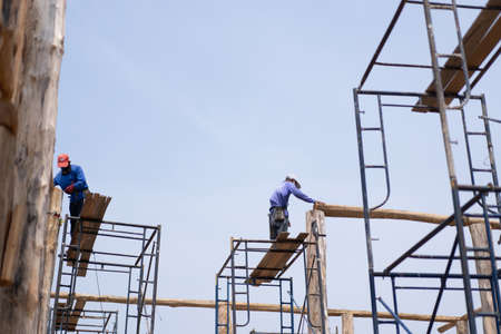 Many men are working on high ground.
