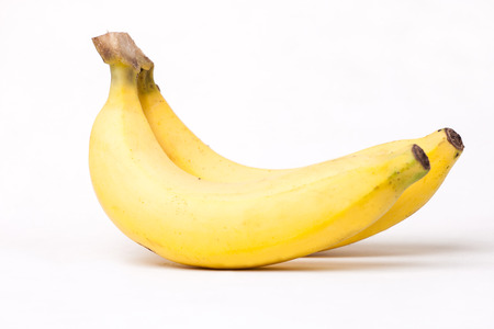 image of two yellow bananas on white backgroundの写真素材