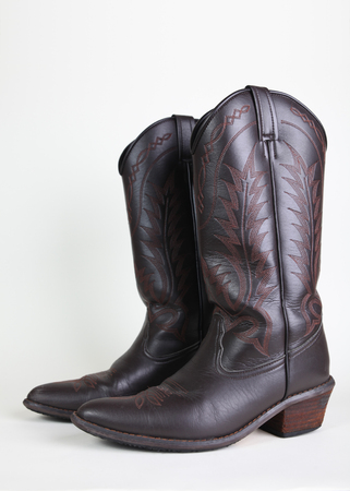 cowboy leather boots on white backgroundの写真素材