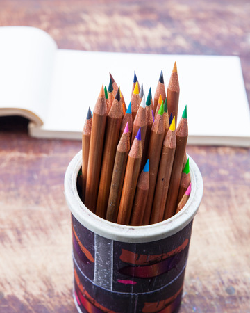 colour pencil on table with notepadの写真素材