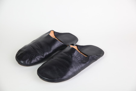 black leather slipper on white backgroundの写真素材