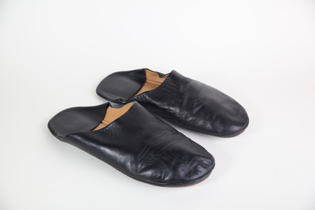 black leather slipper on white backgroundの写真素材
