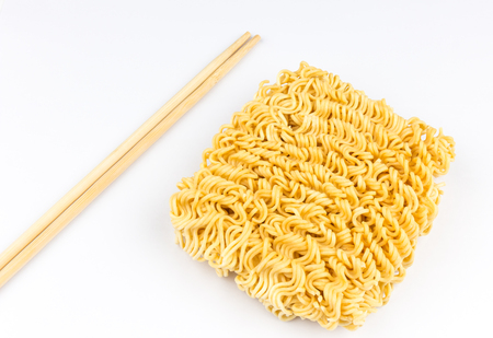 A block of uncooked Ramen Noodles on white background.の写真素材