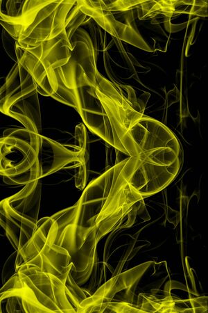 Yellow smoke on black background, movement of white smokeの写真素材