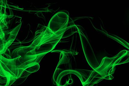 Green smoke on black background, movement of white smokeの写真素材