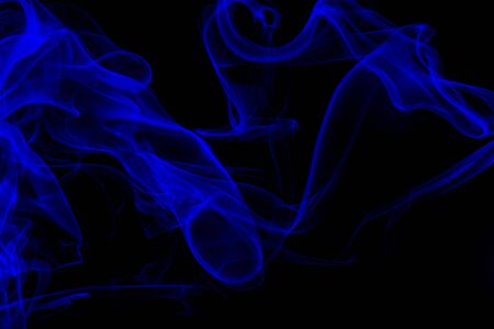 Blue smoke on black background, movement of white smokeの写真素材