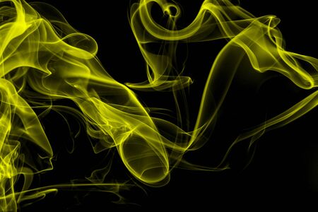 Yellow smoke on black background, movement of white smokeの写真素材